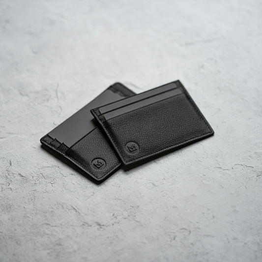 black leather bifold wallet on white surface