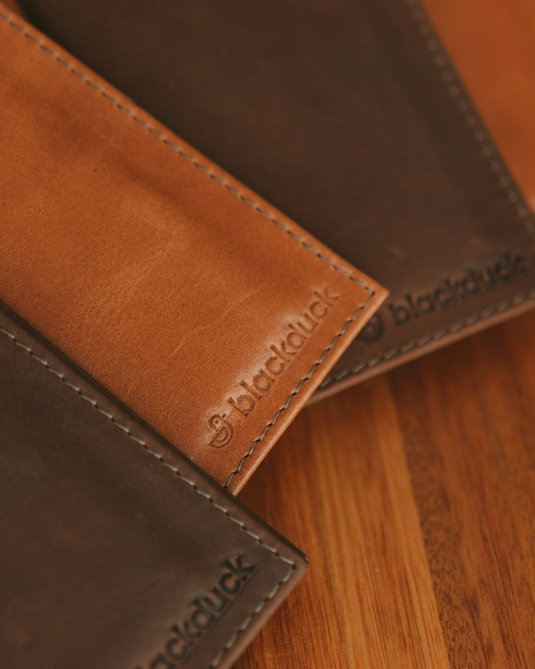 a close up of a wallet on a wooden surface