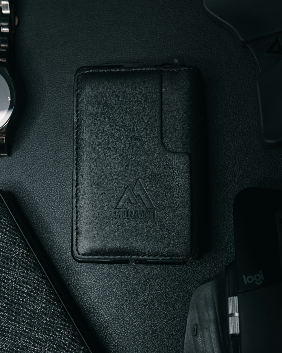 a wallet, watch, and other items on a table