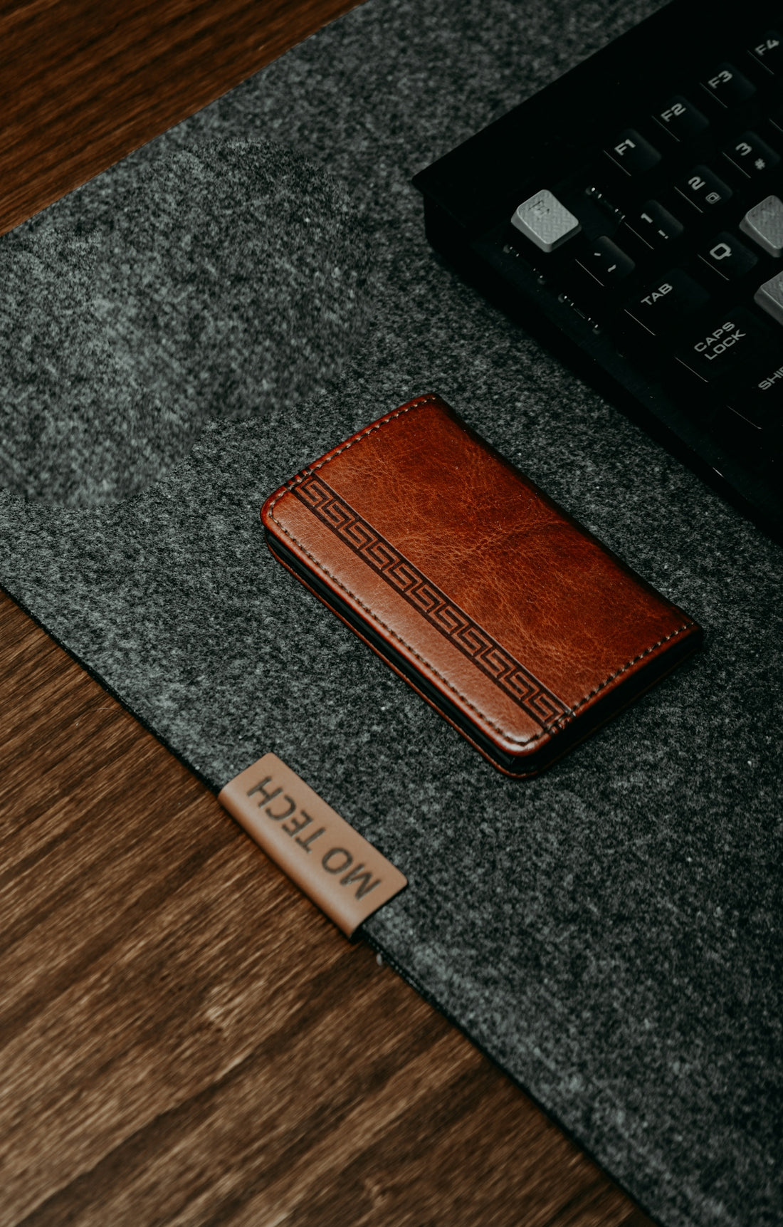 a brown wallet sitting on top of a wooden table
