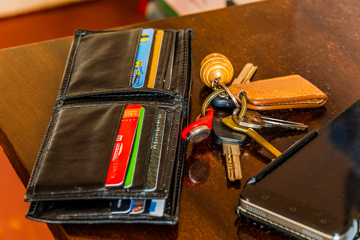 a wallet and keys on a table