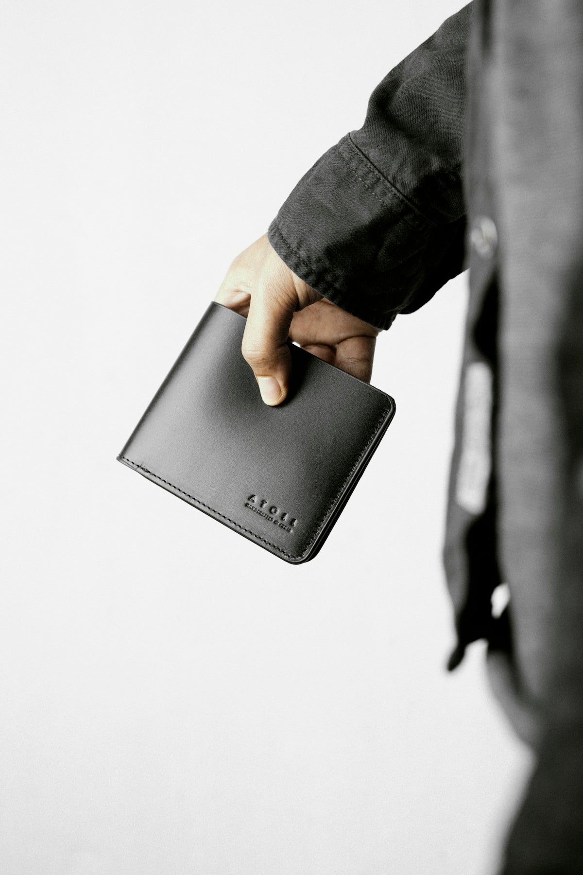 a person holding a wallet in their hand