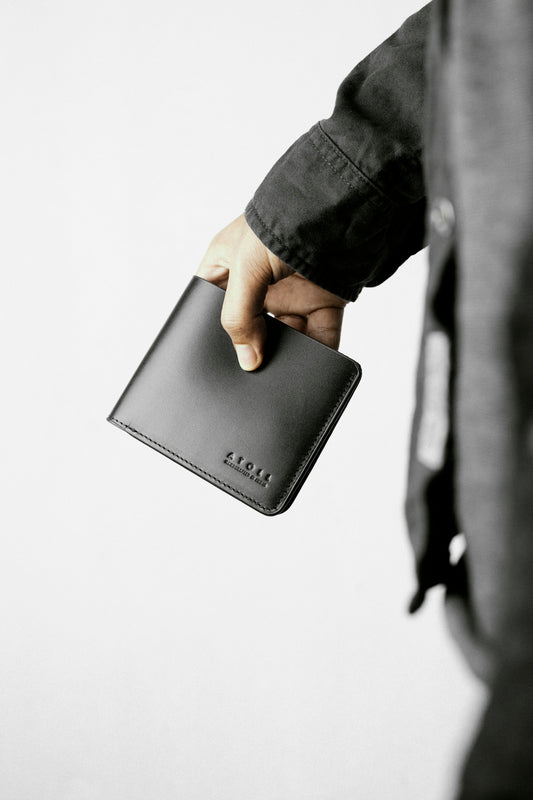 a person holding a wallet in their hand